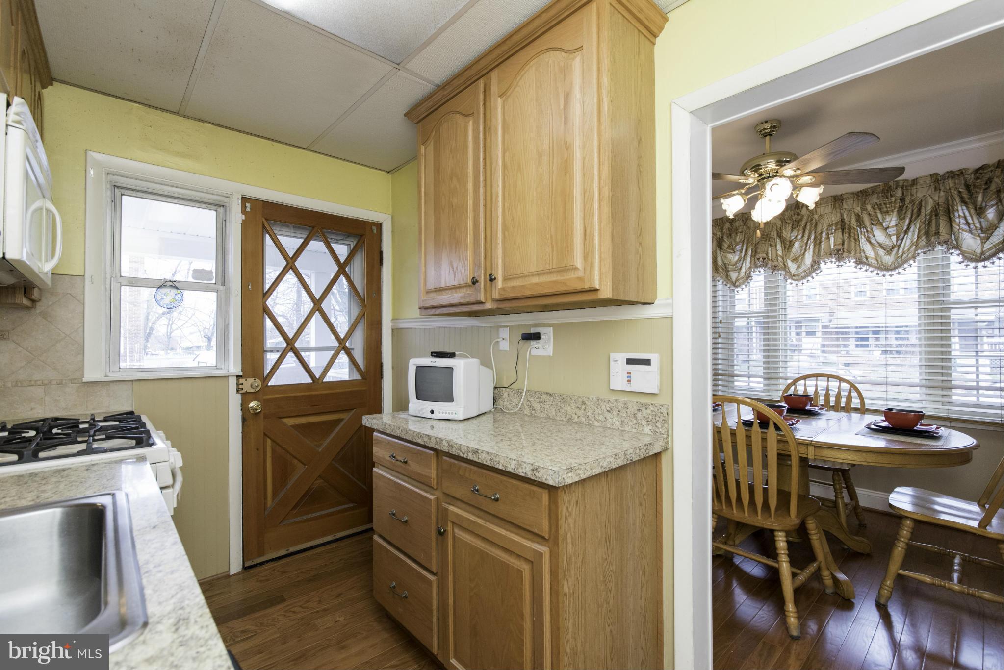 1900 Barry Road Baltimore, MD 21222 - Photo 16 of 30 a kitchen that has a cabinets and a table in it