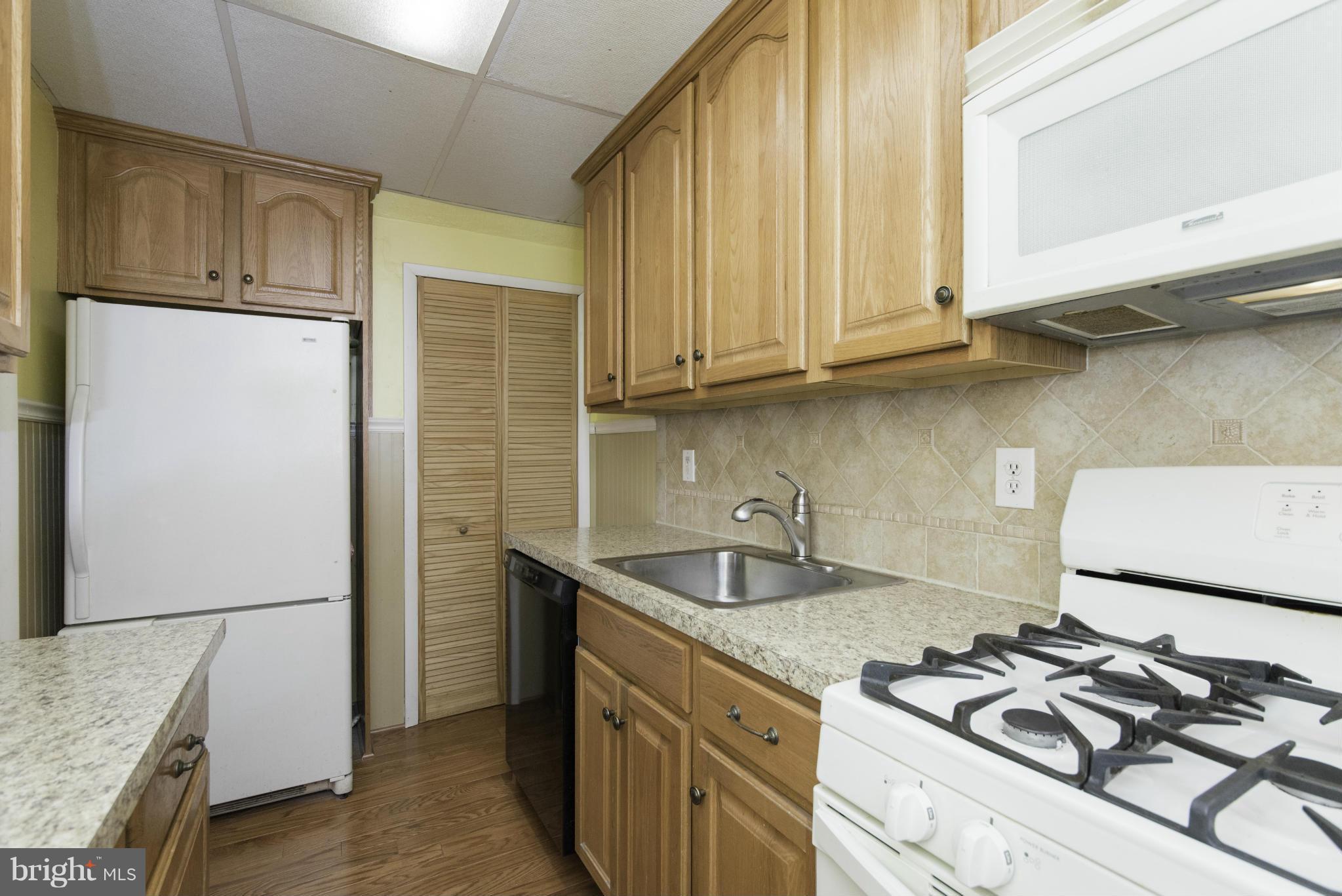 1900 Barry Road Baltimore, MD 21222 - Photo 17 of 30 a kitchen with stainless steel appliances granite countertop a sink stove and refrigerator