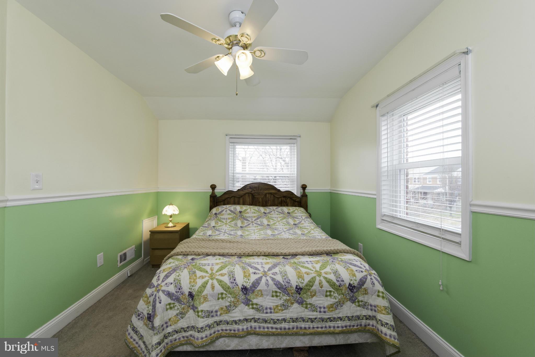 1900 Barry Road Baltimore, MD 21222 - Photo 19 of 30 a bed sitting in a bedroom next to a window