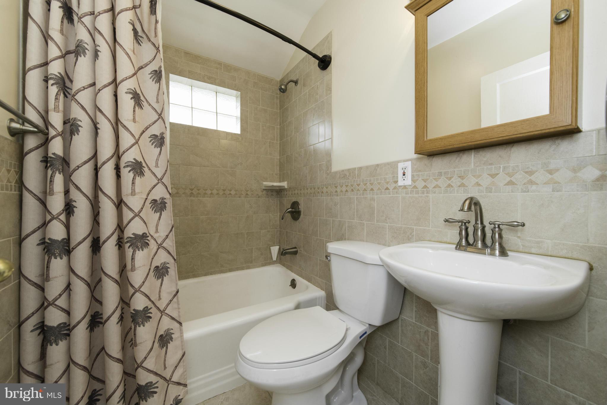 1900 Barry Road Baltimore, MD 21222 - Photo 21 of 30 a bathroom with a sink a toilet and shower