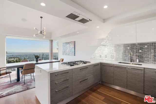 a kitchen with a sink stove and cabinets
