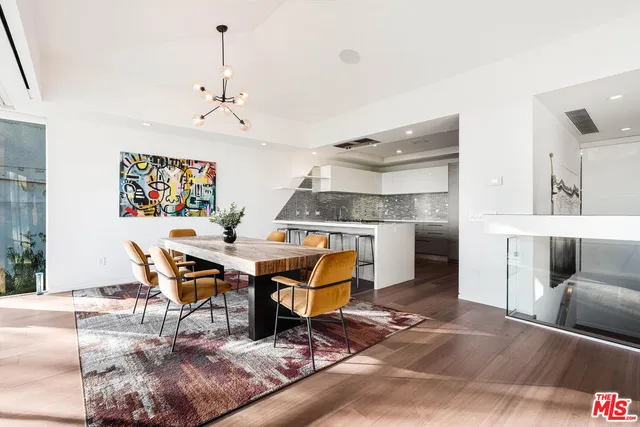 a living room with furniture a dining table and chairs