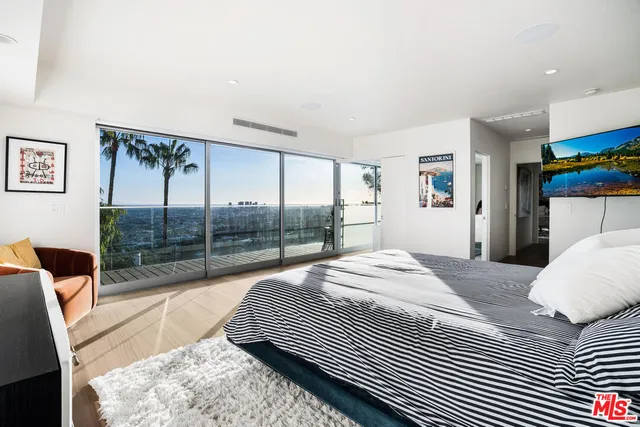 a bedroom with a bed and glass door