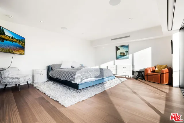 a spacious bedroom with a bed and couch