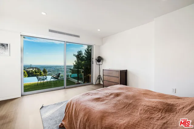 a bed sitting in a bedroom next to a yard