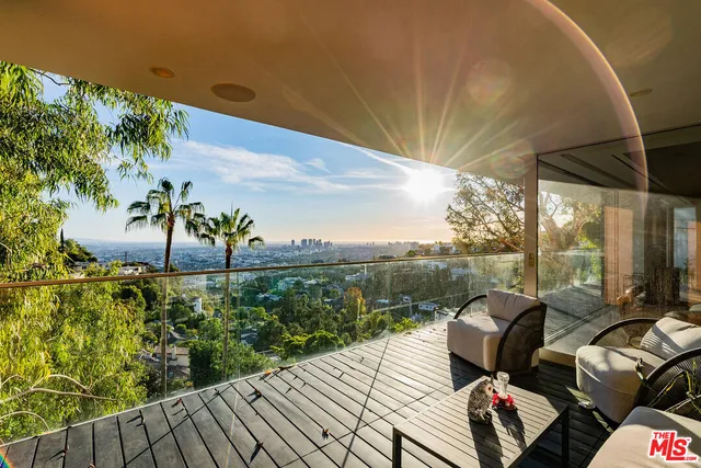 a view of balcony with furniture and garden