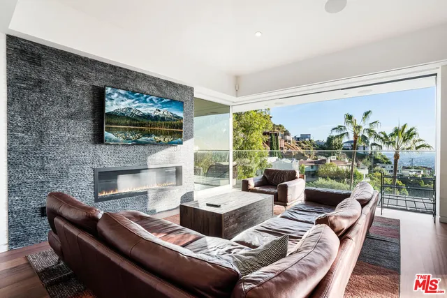a living room with fireplace furniture and a flat screen tv