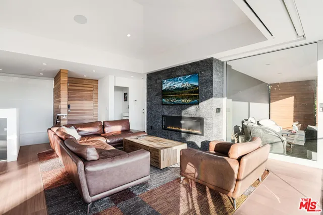 a living room with fireplace furniture and a flat screen tv