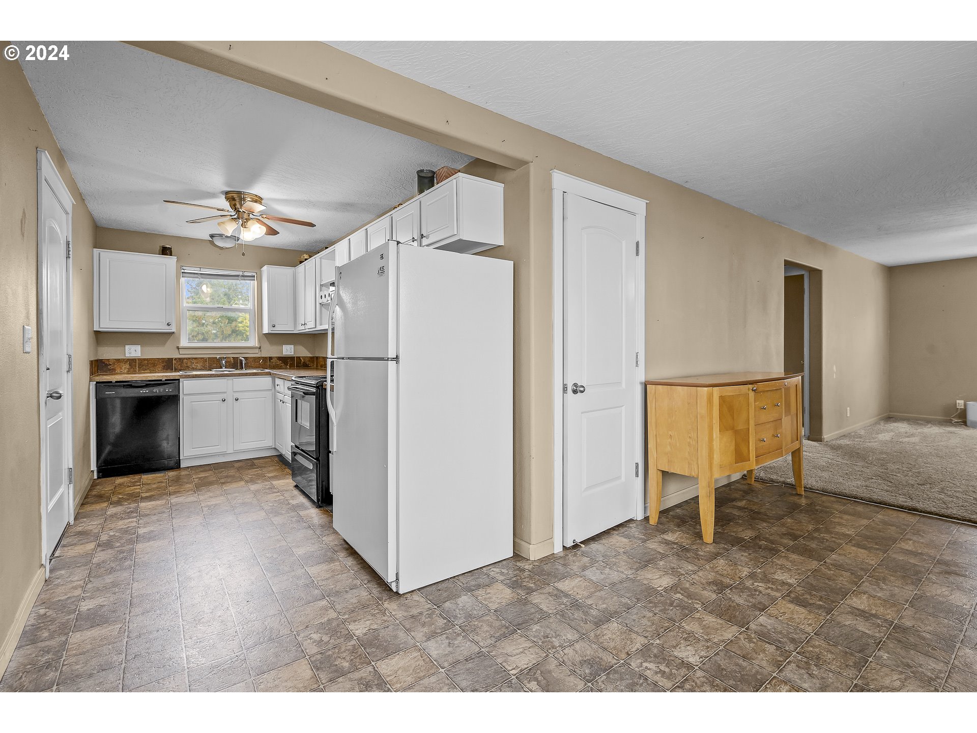 1275 30th Street Springfield, OR 97478 - Photo 8 of 28 a view of a kitchen with refrigerator and cabinets