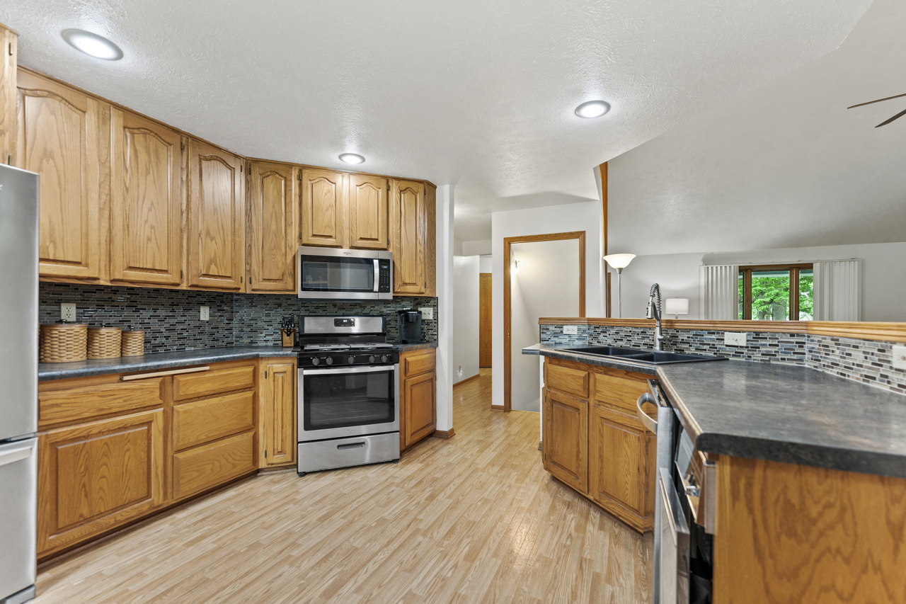 1506 Pier Drive Davis, IL 61019 - Photo 11 of 47 a kitchen with stainless steel appliances granite countertop a stove a sink and a microwave
