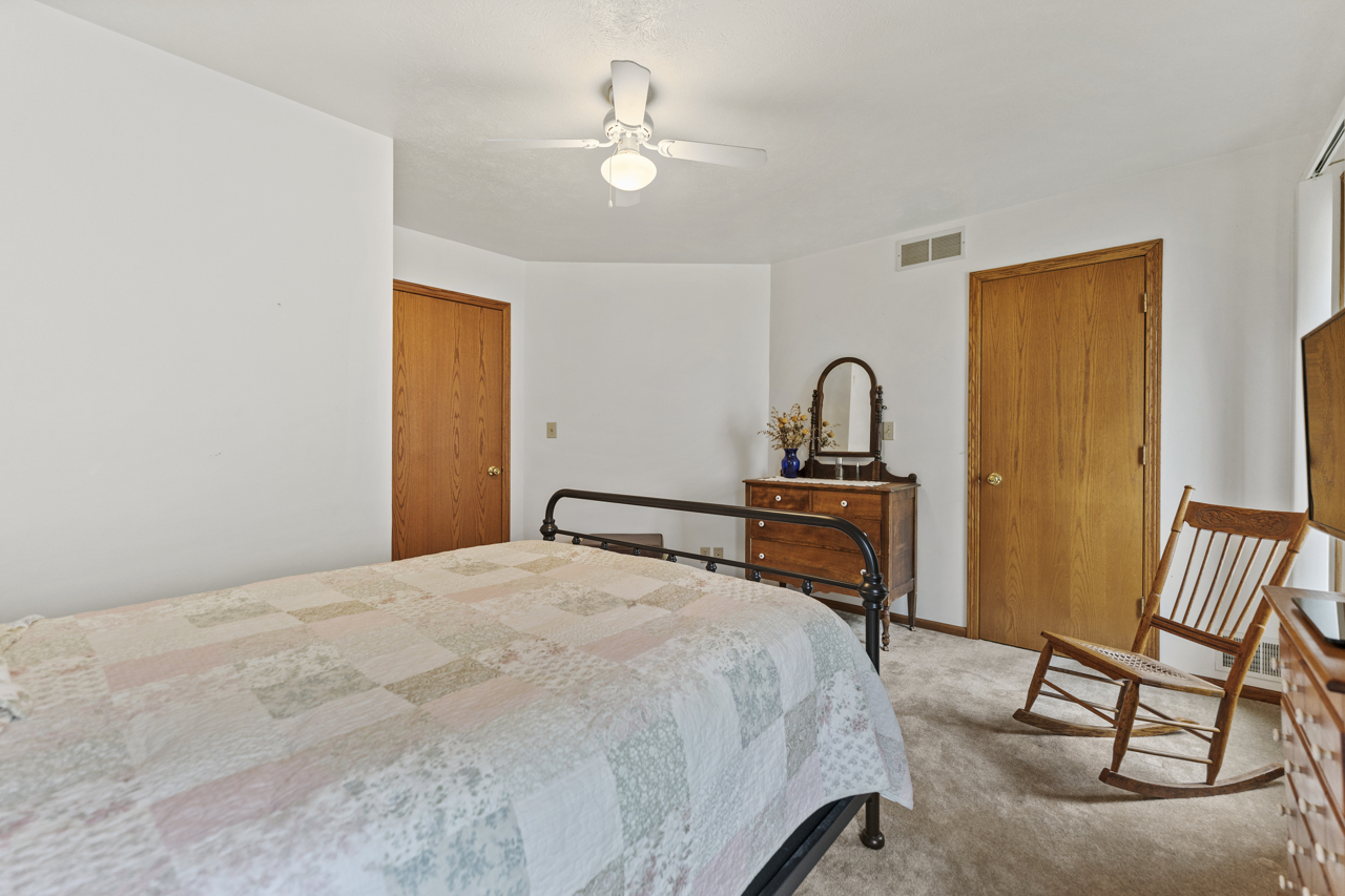 1506 Pier Drive Davis, IL 61019 - Photo 23 of 47 a bedroom with a bed and a chandelier