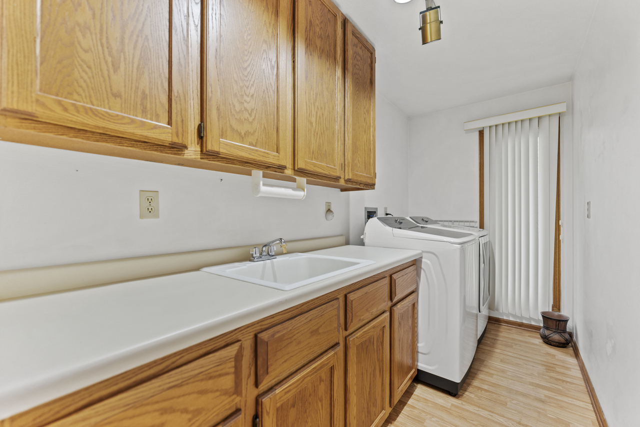 1506 Pier Drive Davis, IL 61019 - Photo 26 of 47 a utility room with stainless steel appliances granite countertop a sink and dishwasher with wooden cabinets