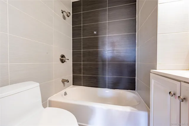 a bathroom with a bathtub a toilet and a shower