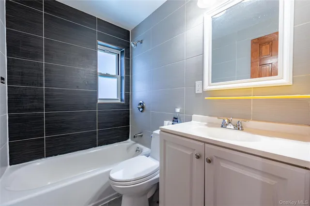 a bathroom with a sink toilet vanity and shower