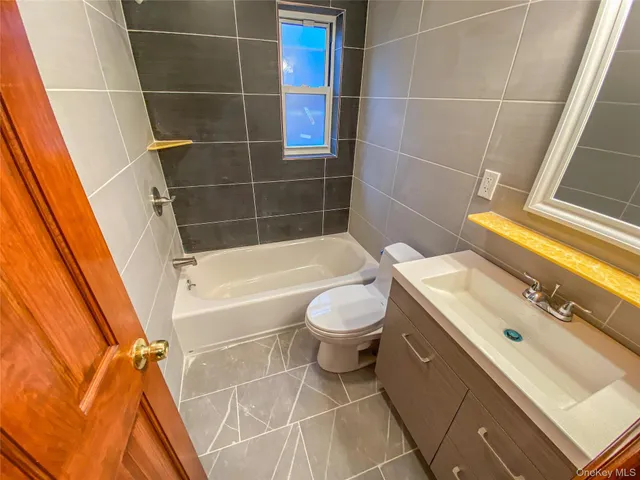 a bathroom with a sink a toilet and bathtub