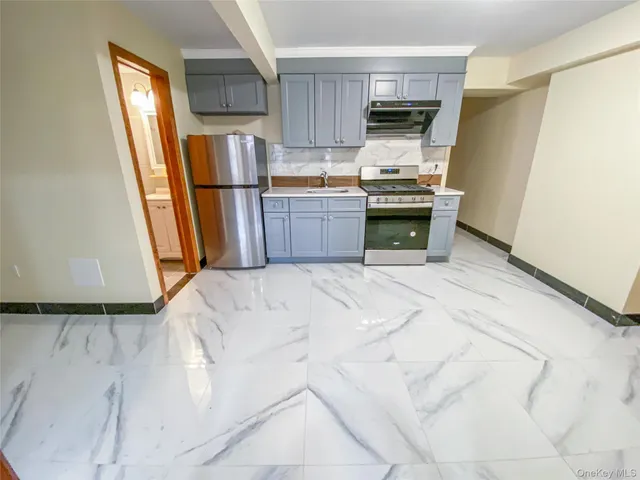 a kitchen with granite countertop a refrigerator and a stove