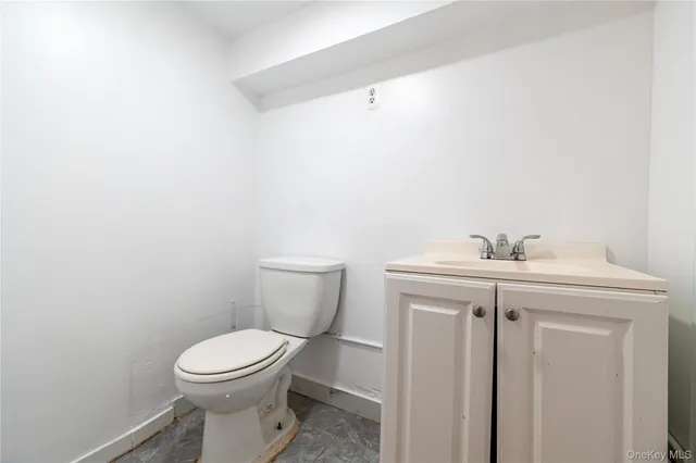 a bathroom with a sink a toilet and mirror