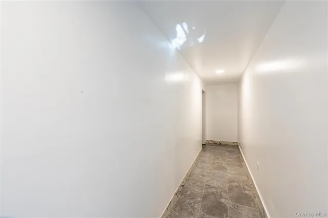 a view of a hallway with a chandelier fan