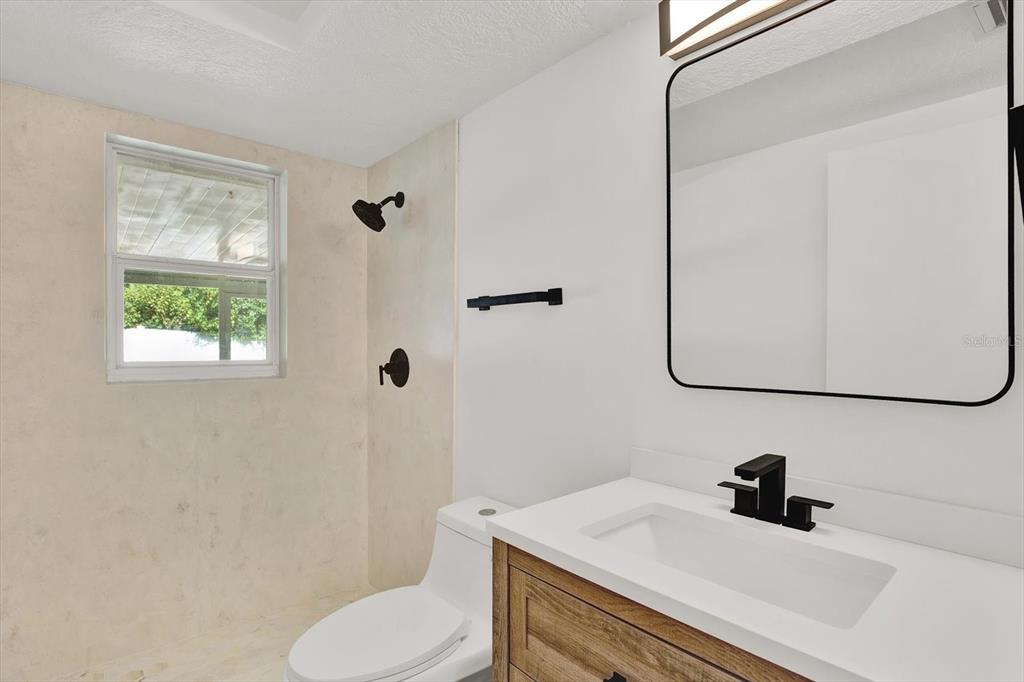 6701 Parkside Drive New Port Richey, FL 34653 - Photo 11 of 26 a bathroom with a sink toilet and shower