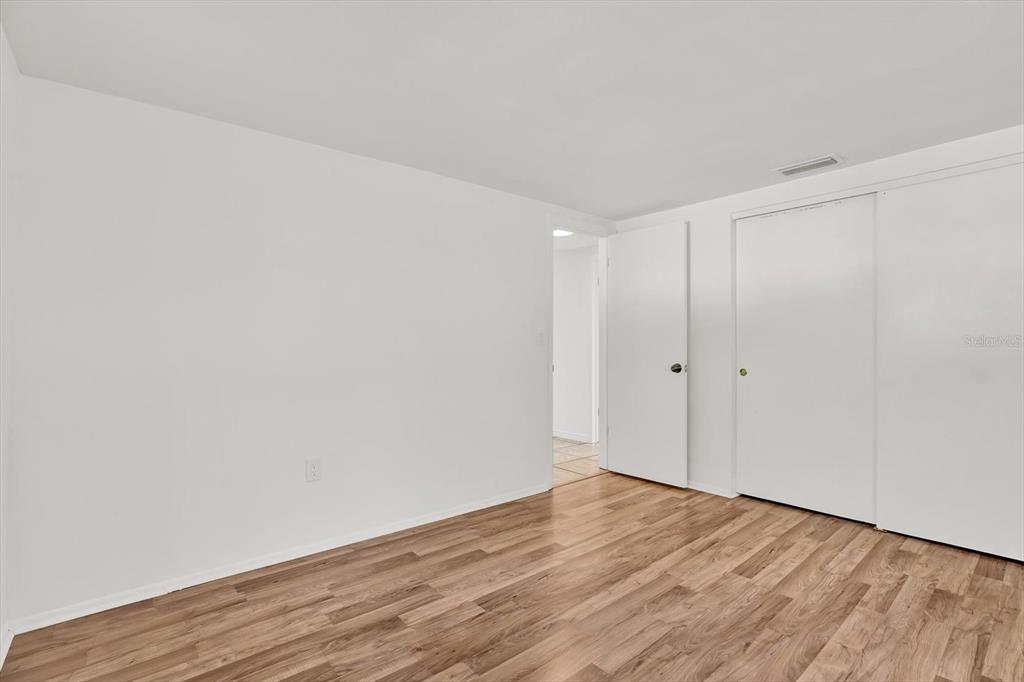6701 Parkside Drive New Port Richey, FL 34653 - Photo 13 of 26 a view of an empty room with wooden floor