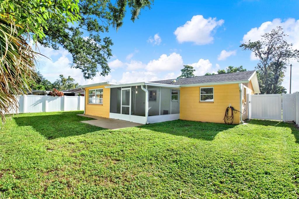 6701 Parkside Drive New Port Richey, FL 34653 - Photo 17 of 26 a view of a house with backyard and garden
