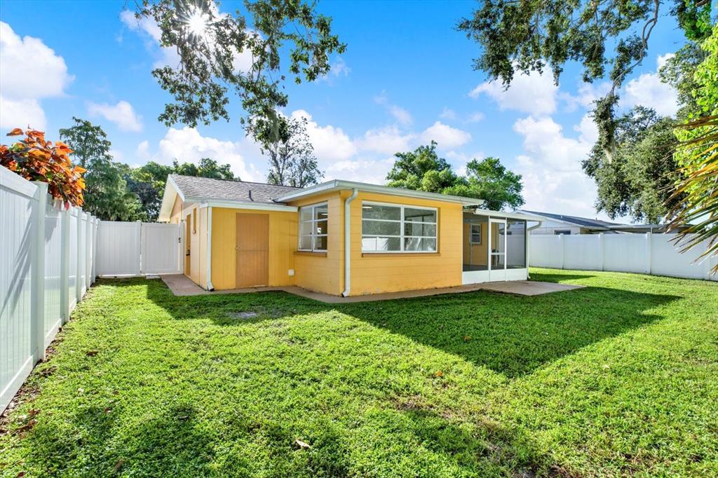 6701 Parkside Drive New Port Richey, FL 34653 - Photo 18 of 26 a view of a house with backyard and a tree