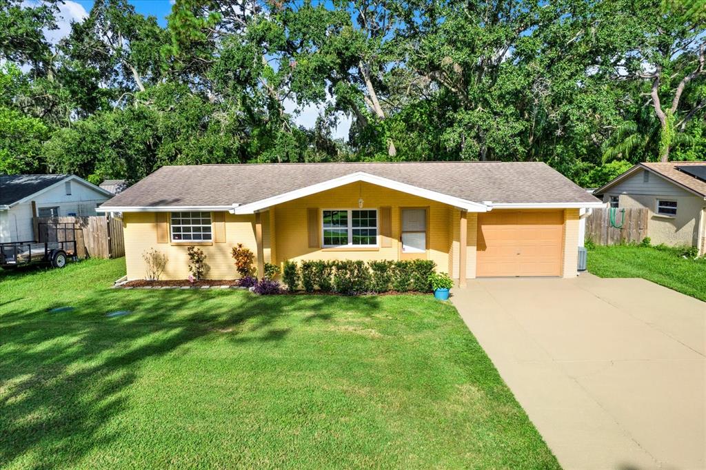 6701 Parkside Drive New Port Richey, FL 34653 - Photo 20 of 26 a front view of a house with a garden