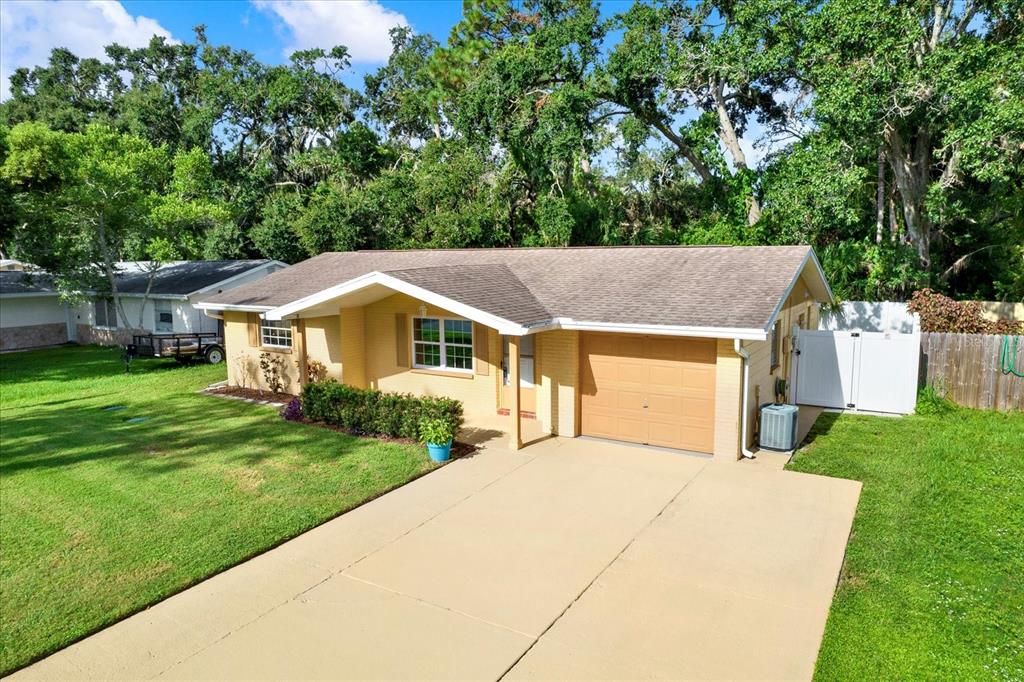 6701 Parkside Drive New Port Richey, FL 34653 - Photo 21 of 26 a house with green field in front of it