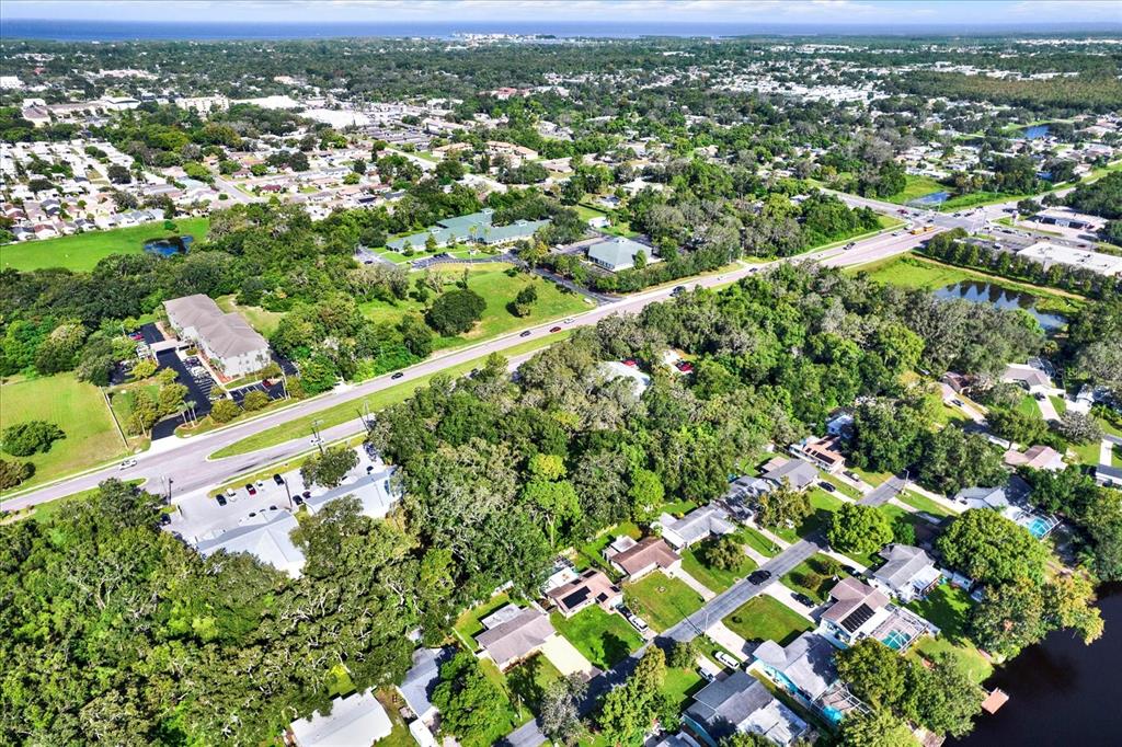 6701 Parkside Drive New Port Richey, FL 34653 - Photo 23 of 26 an aerial view of residential houses with outdoor space and trees