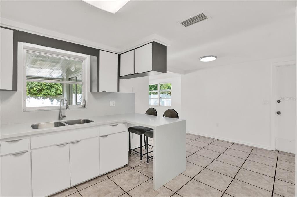 6701 Parkside Drive New Port Richey, FL 34653 - Photo 4 of 26 a kitchen with a sink cabinets and window