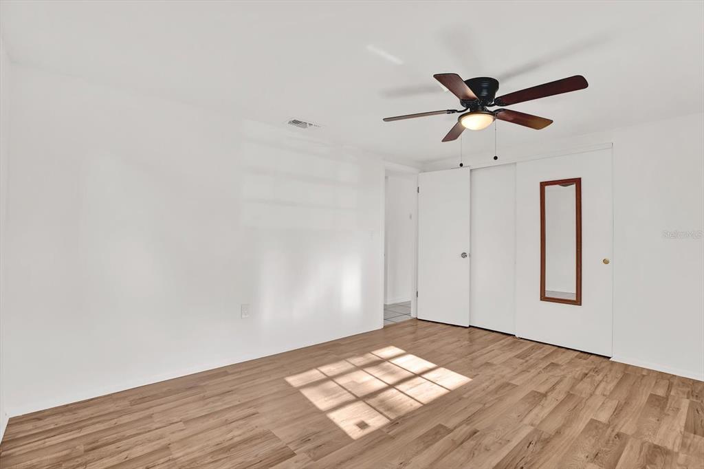 6701 Parkside Drive New Port Richey, FL 34653 - Photo 10 of 26 a view of empty room with wooden floor and fan