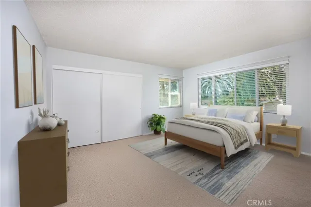 a bedroom with a bed and window