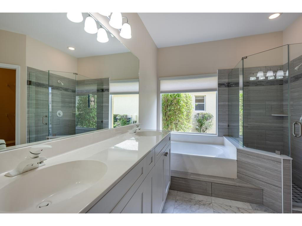 2011 Timarron Way Naples, FL 34109 - Photo 12 of 18 a bathroom with a sink mirror and a bathtub