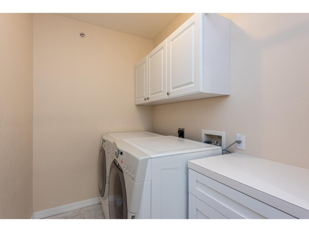 2011 Timarron Way Naples, FL 34109 - Photo 18 of 18 a utility room with dryer and washer