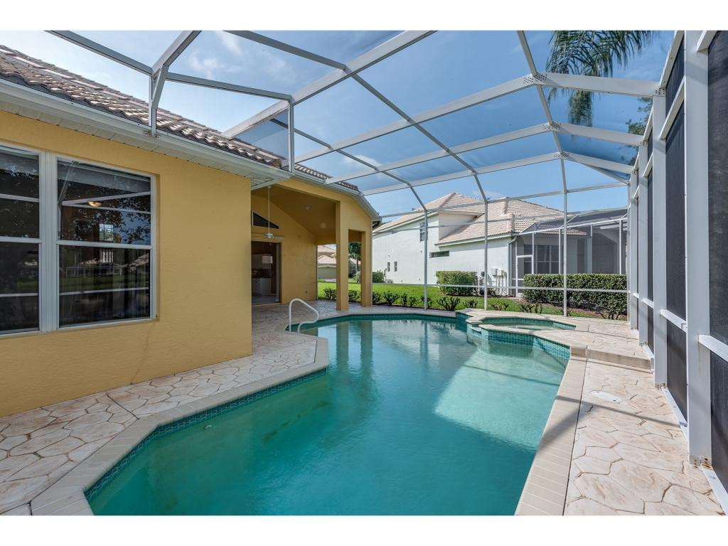 2011 Timarron Way Naples, FL 34109 - Photo 3 of 18 a view of a swimming pool with a patio