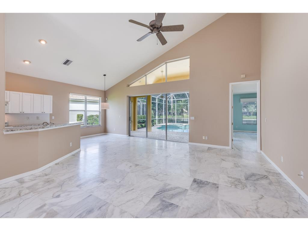 2011 Timarron Way Naples, FL 34109 - Photo 6 of 18 a view of an empty room with kitchen and a window