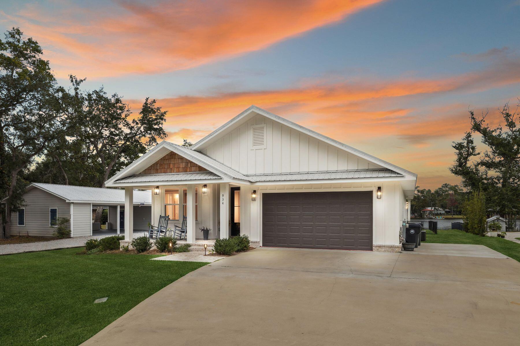 a front view of a house with yard and green space