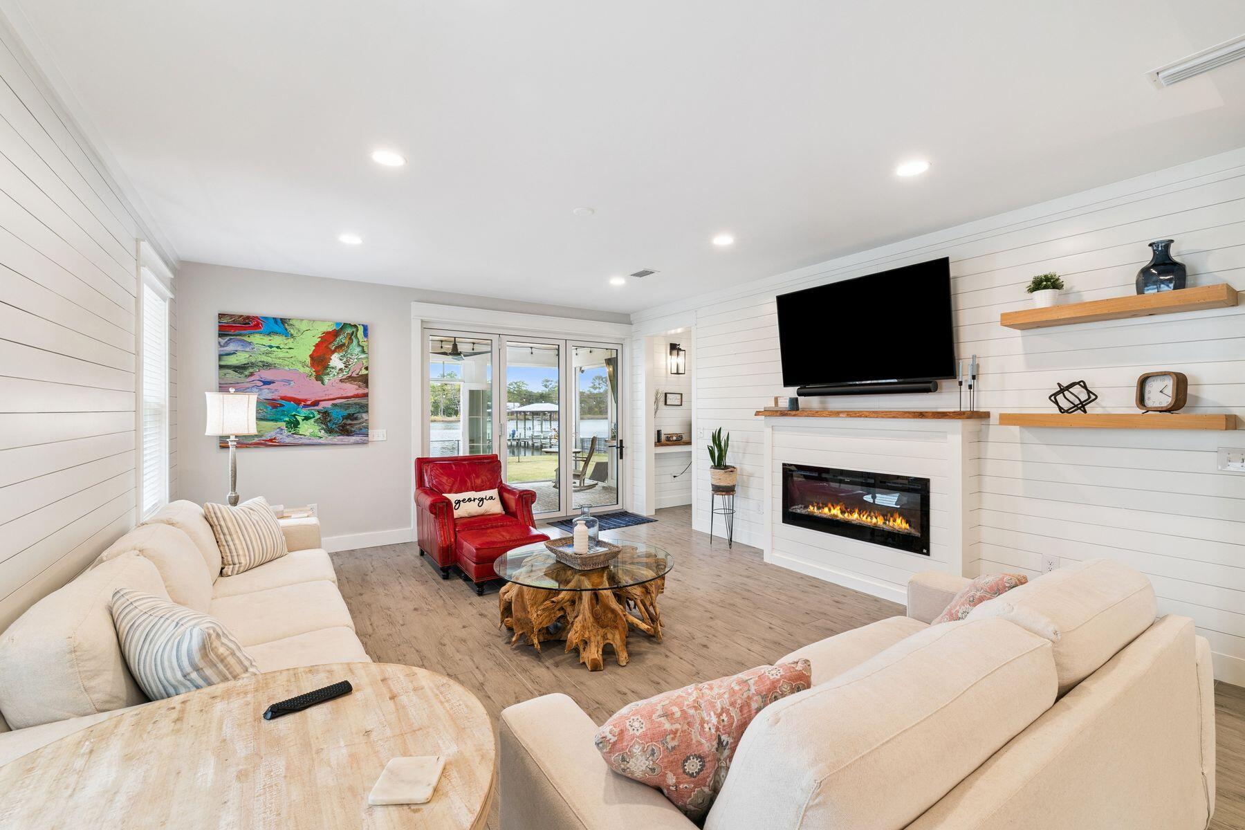 934 Bay Grove Road Freeport, FL 32439 - Photo 16 of 37 a living room with furniture a fireplace and a flat screen tv
