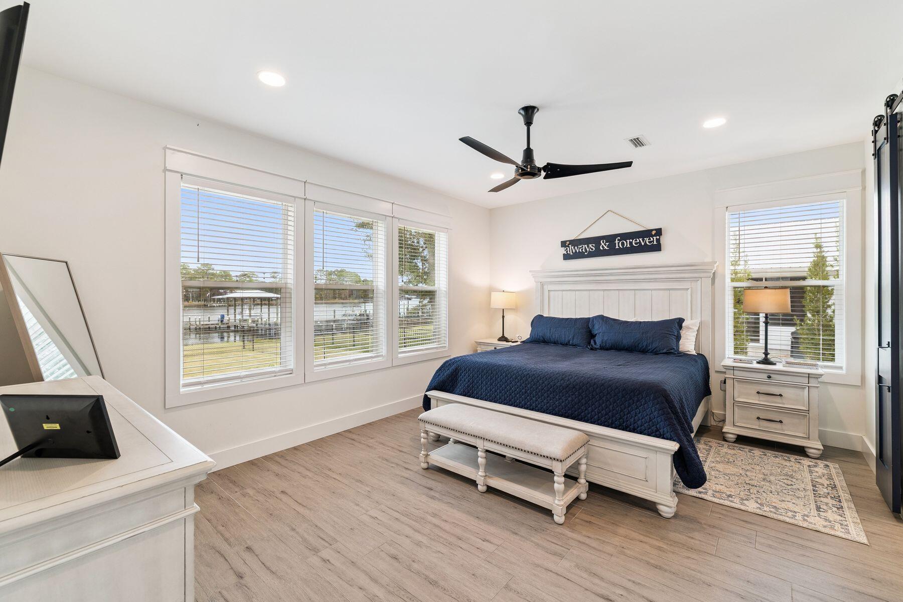 934 Bay Grove Road Freeport, FL 32439 - Photo 19 of 37 a bedroom with a bed wooden floor and window