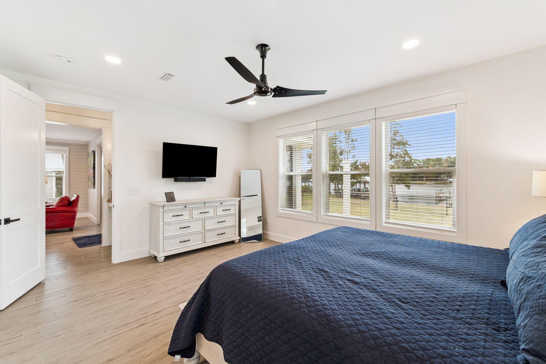 934 Bay Grove Road Freeport, FL 32439 - Photo 20 of 37 a spacious bedroom with a bed and a flat screen tv