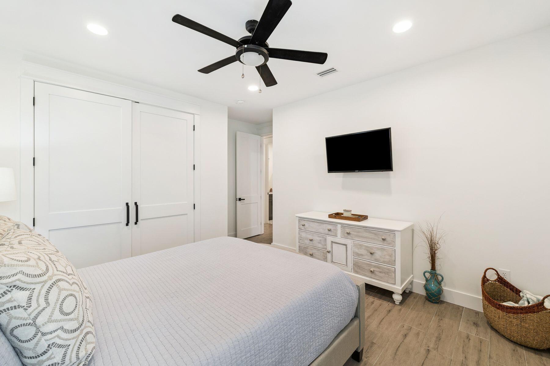 934 Bay Grove Road Freeport, FL 32439 - Photo 24 of 37 a bedroom with a bed and a flat screen tv