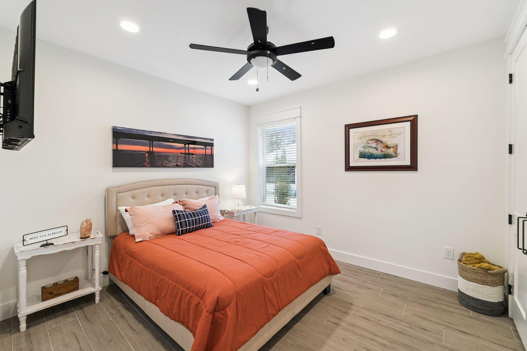 934 Bay Grove Road Freeport, FL 32439 - Photo 25 of 37 a bedroom with a bed and a chandelier