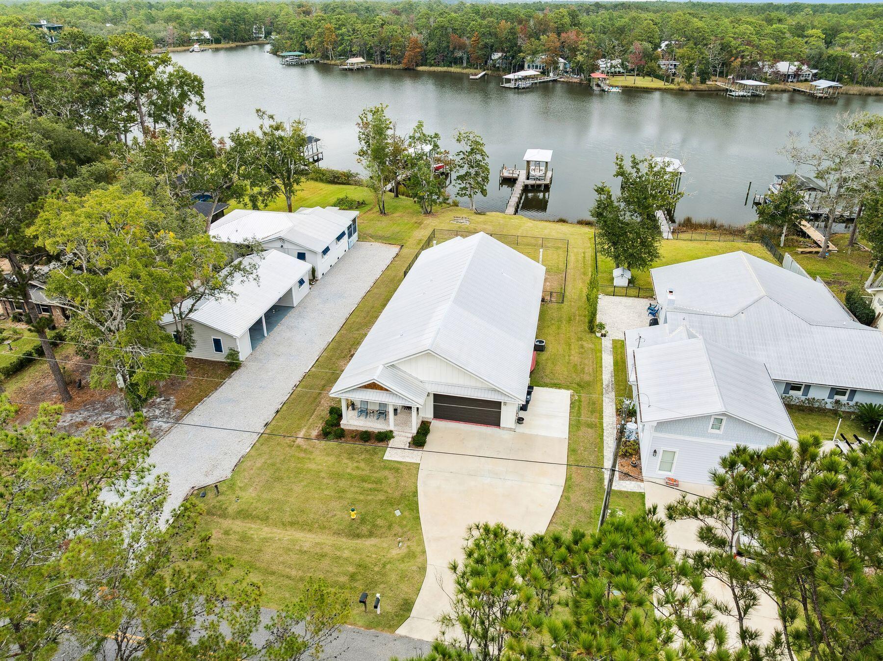 934 Bay Grove Road Freeport, FL 32439 - Photo 3 of 37 an aerial view of a house with swimming pool and lake view