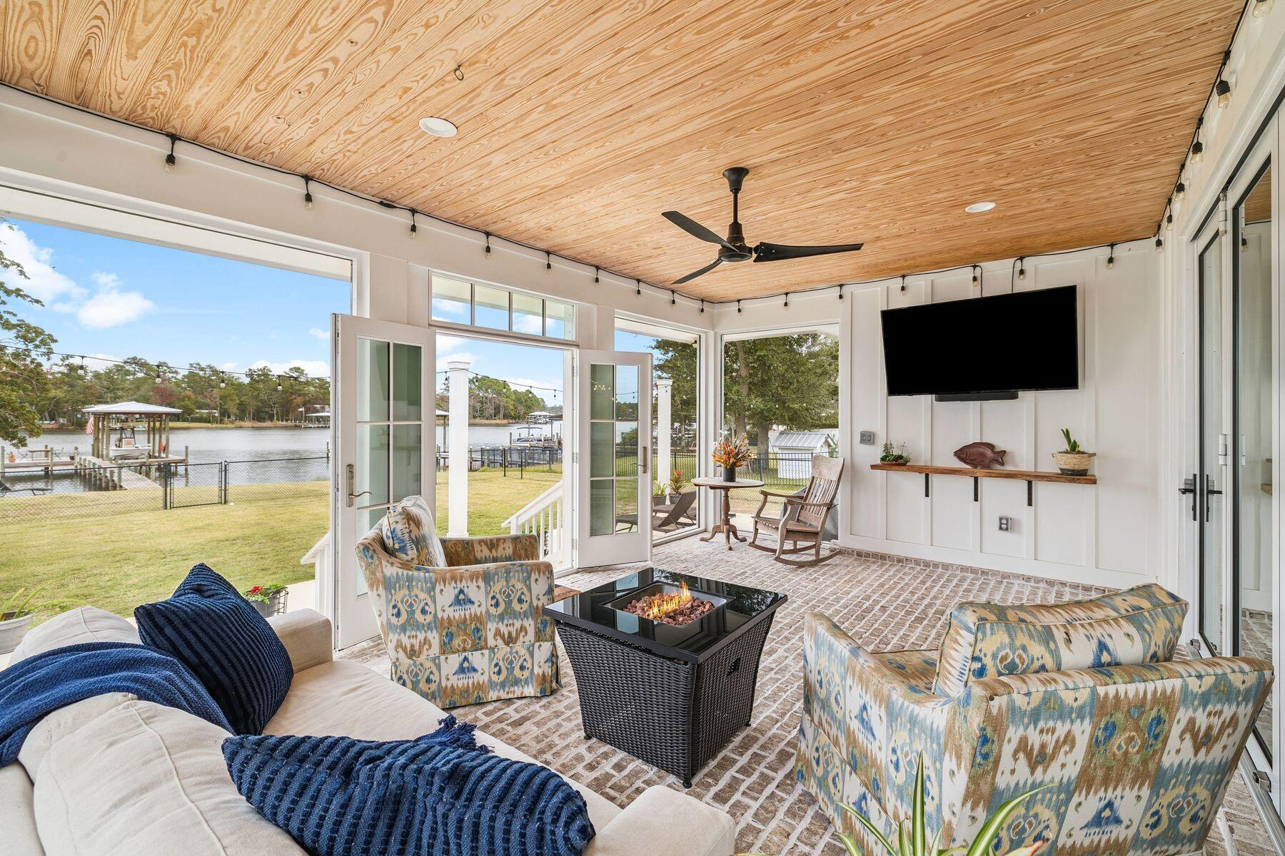 934 Bay Grove Road Freeport, FL 32439 - Photo 32 of 37 a living room with furniture and a flat screen tv