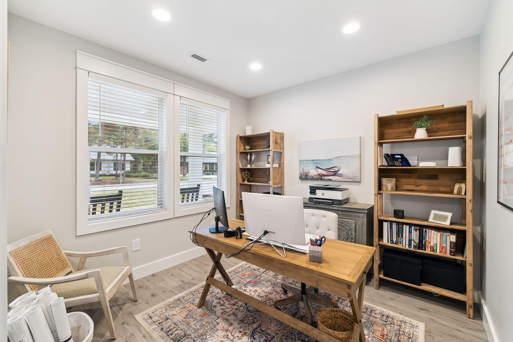 934 Bay Grove Road Freeport, FL 32439 - Photo 6 of 37 a living room with furniture a bookshelf and a window
