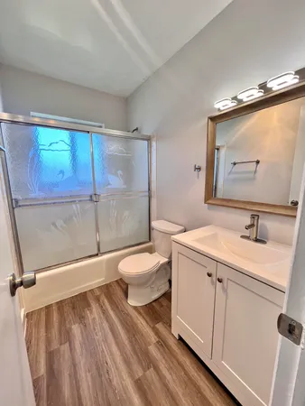 a bathroom with a sink toilet and shower