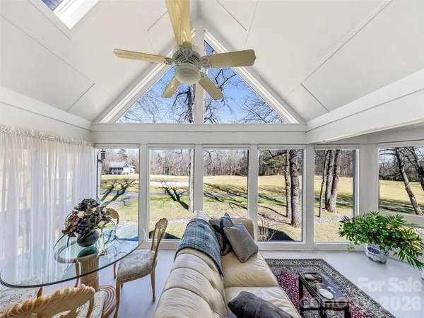 a living room with furniture and a floor to ceiling window