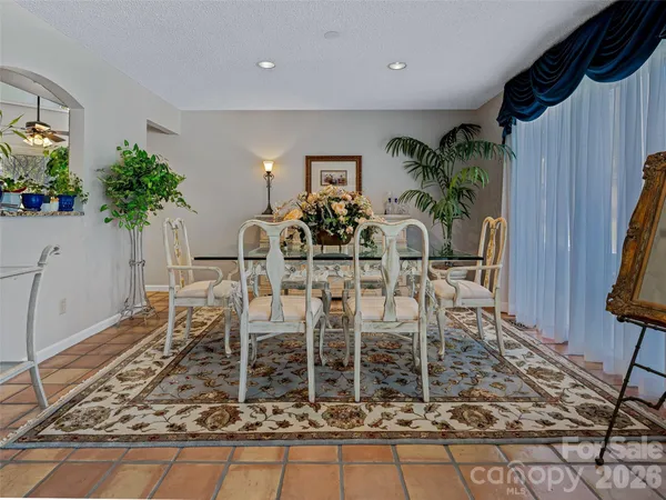 a view of a dining room with furniture a rug and wooden floor