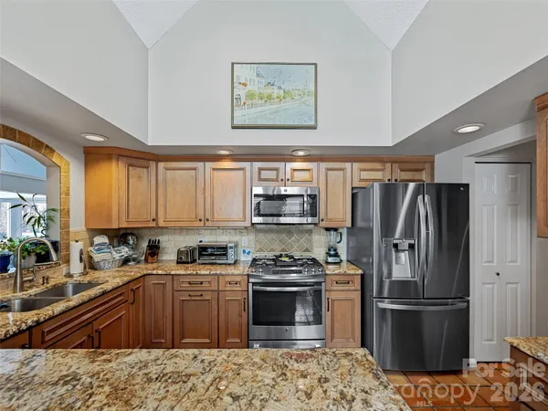 a kitchen with a sink stove and cabinets