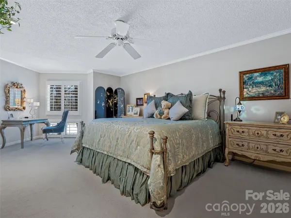 a bedroom with a large bed and a dresser